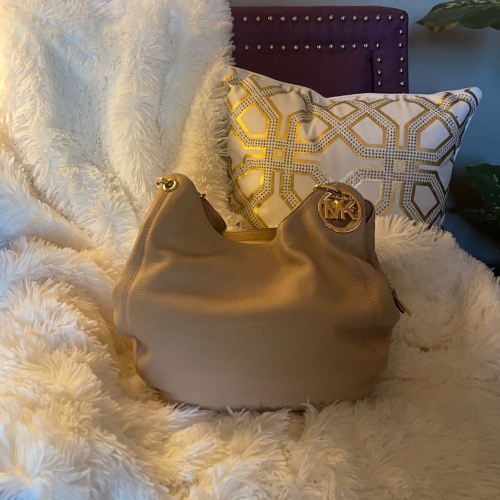 MK hobo style bag with three compartments.